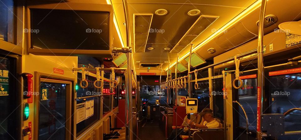 A retro-style bus with a warm yellow light interior.