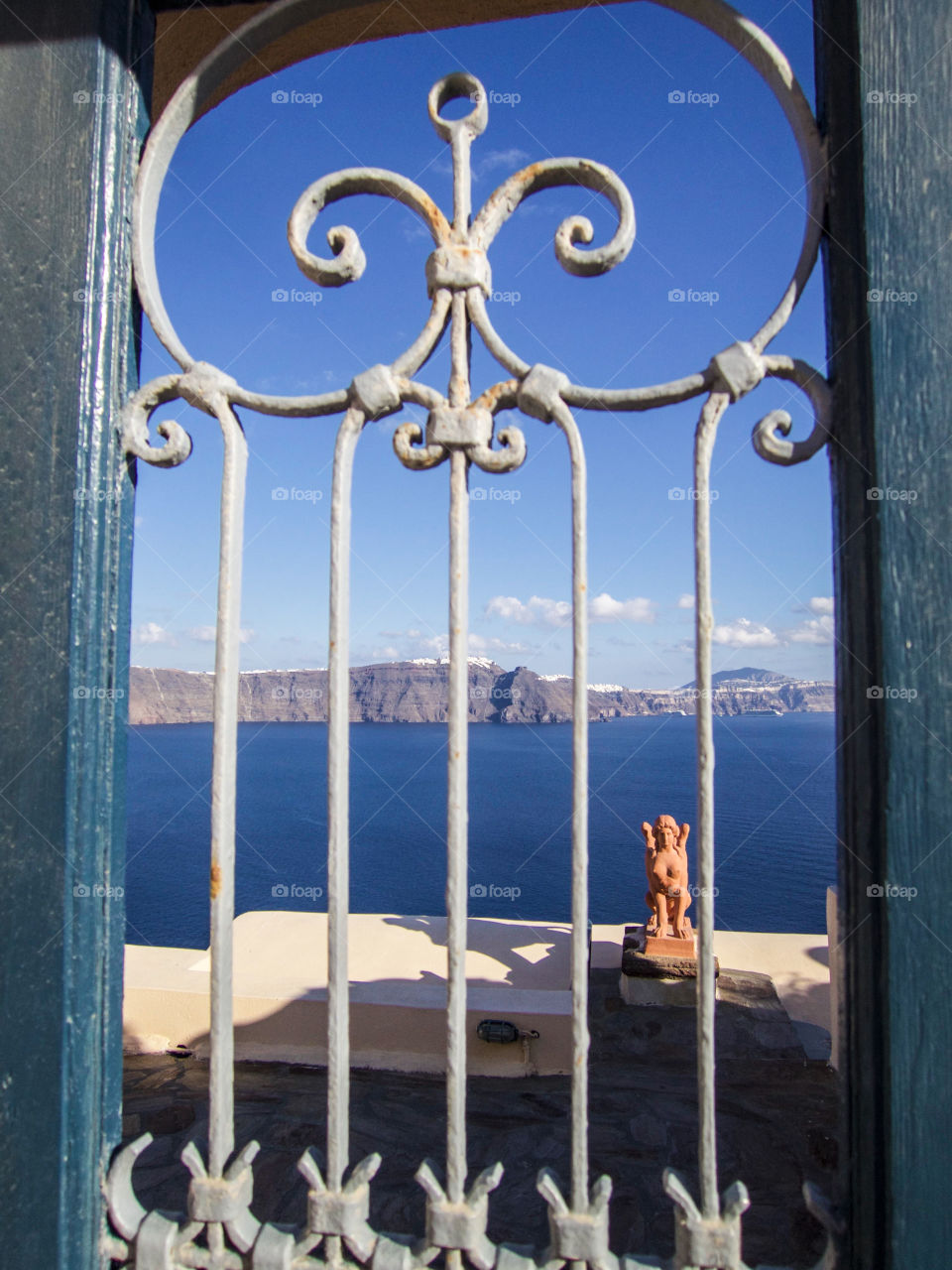 Statue behind a fence. 