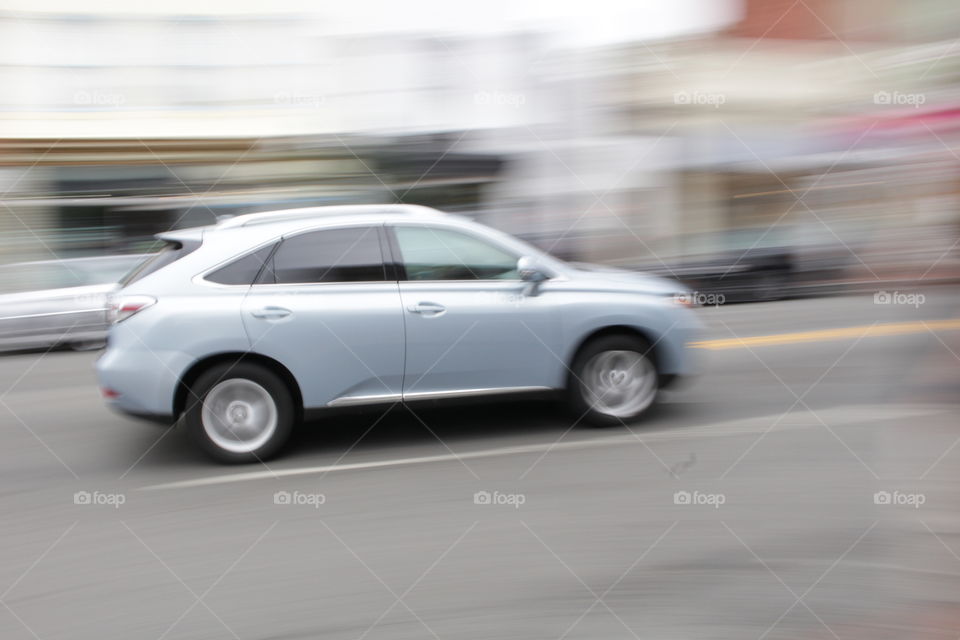lexus on the move . white Lexus car moving light speed with blurring of the city