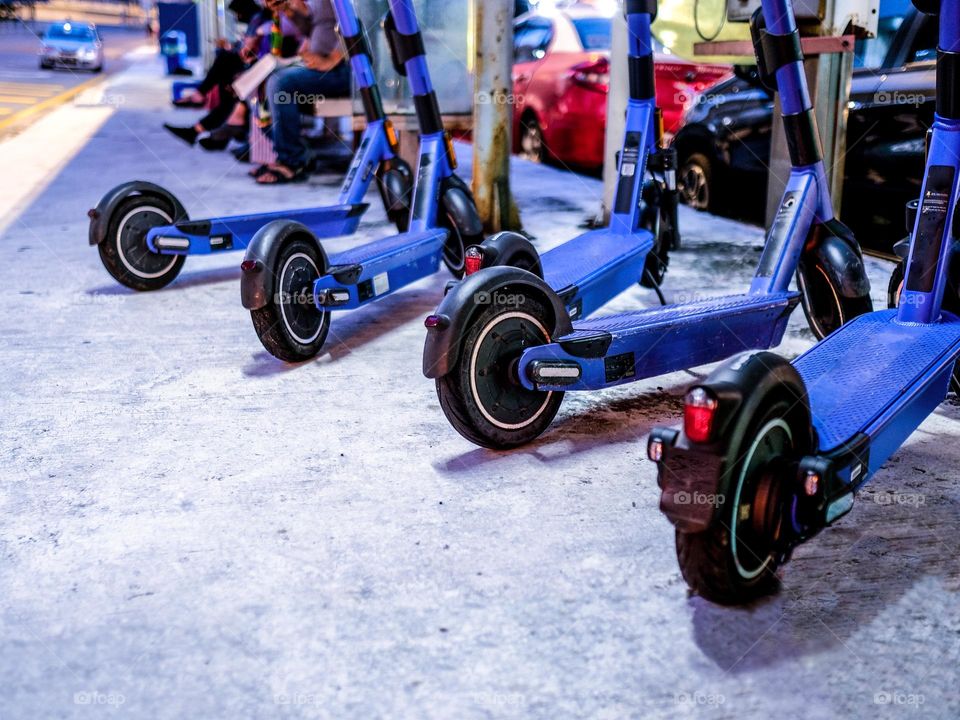 High angle view of electric scooters parked at the bus stop in the city