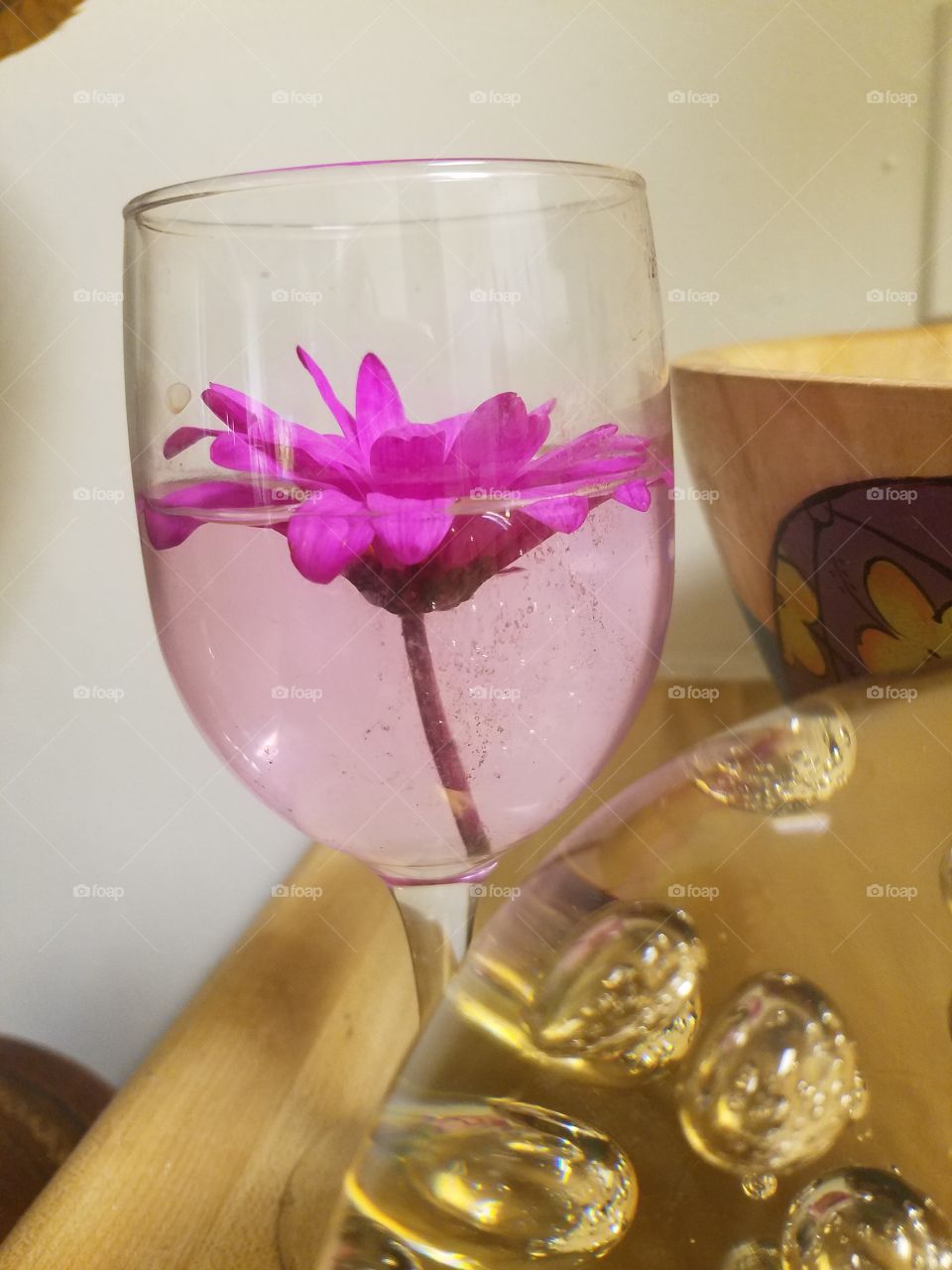 flower floating in a wine glass
