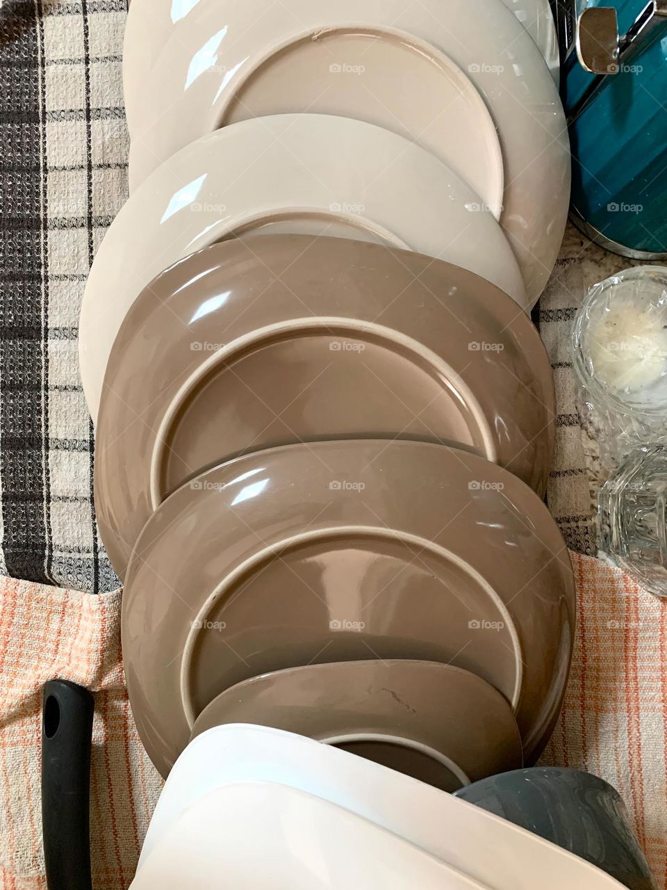 Washing Dishes, Piling Up Plates After Working On Cleaning And Drying Laying Flat On Surface