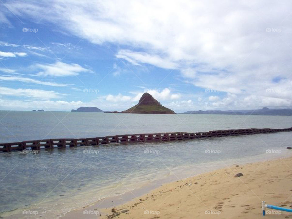 Chinaman's  Hat. This small island is called Chinaman's Hat for obvious reasons.  It is located off the north shore of Oahu Hawaii.