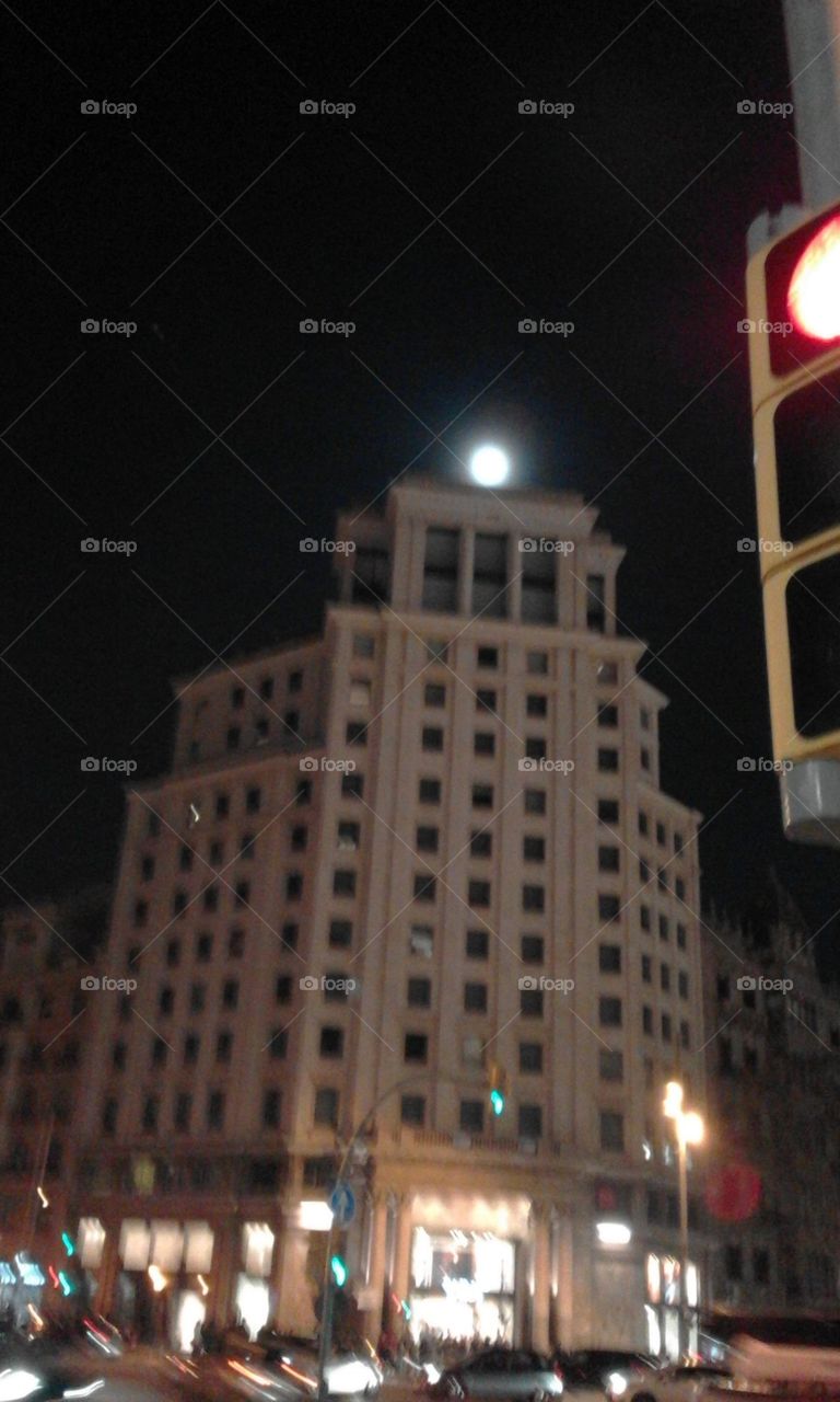 Moon is resting in the building's top.