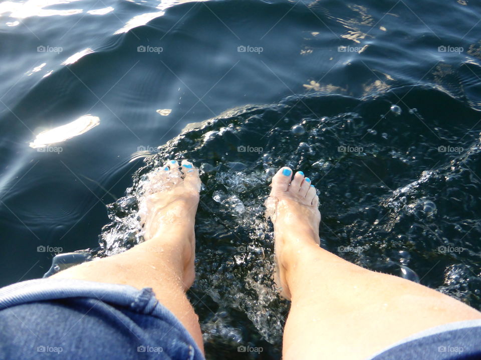 Feets hanging over the boat