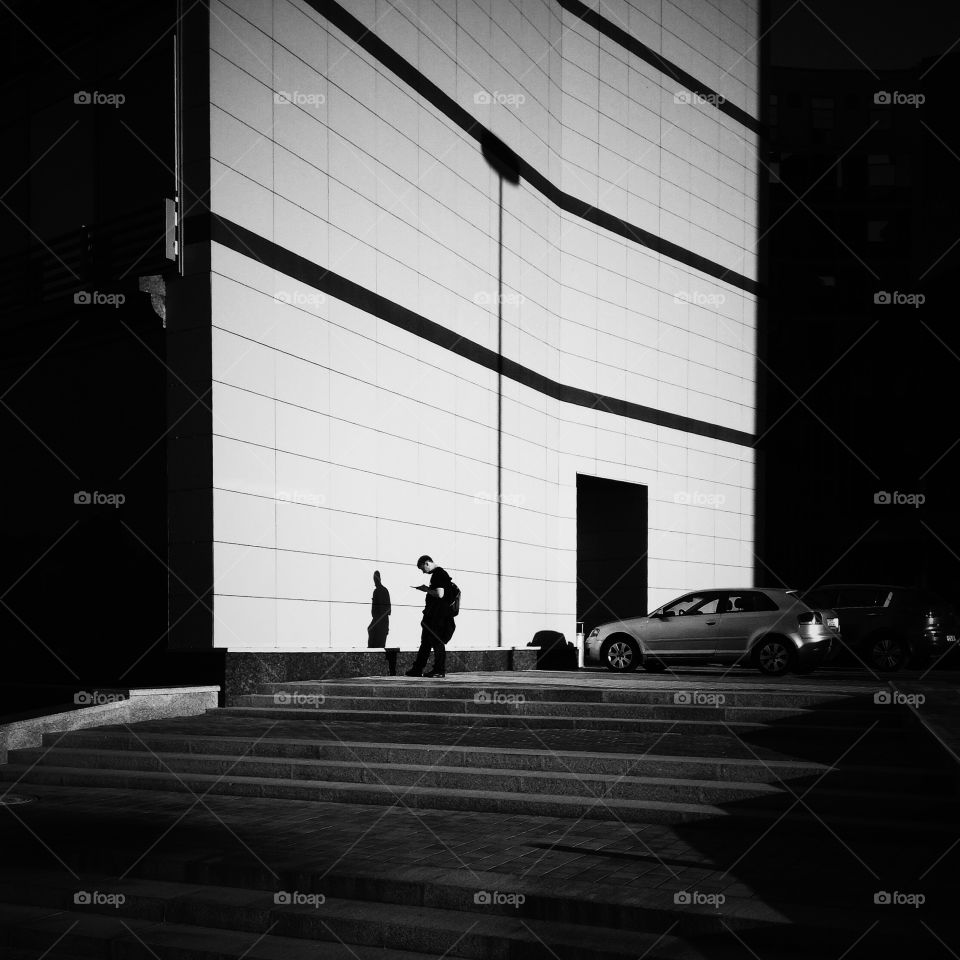 Car and man near building