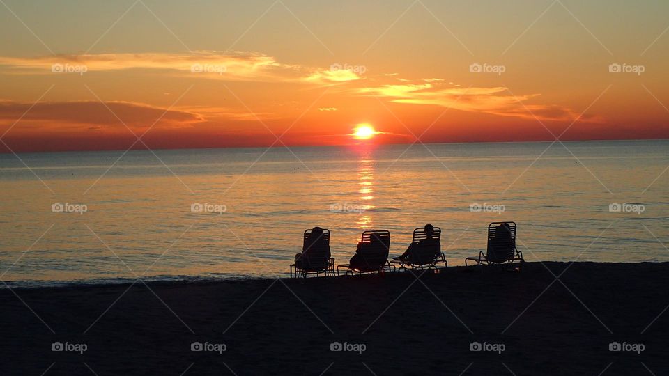 Love is more than just a feeling when sharing an awe inspiring golden sunset with family and friends on a local beach in Sarasota Florida USA, a home away from home