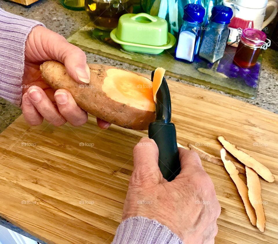 Hands Peeling Sweet Potato