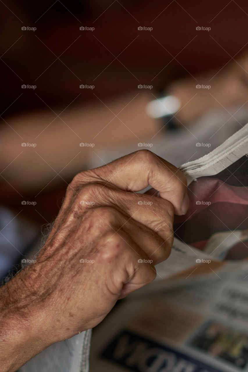 Aging Hand and Newspaper