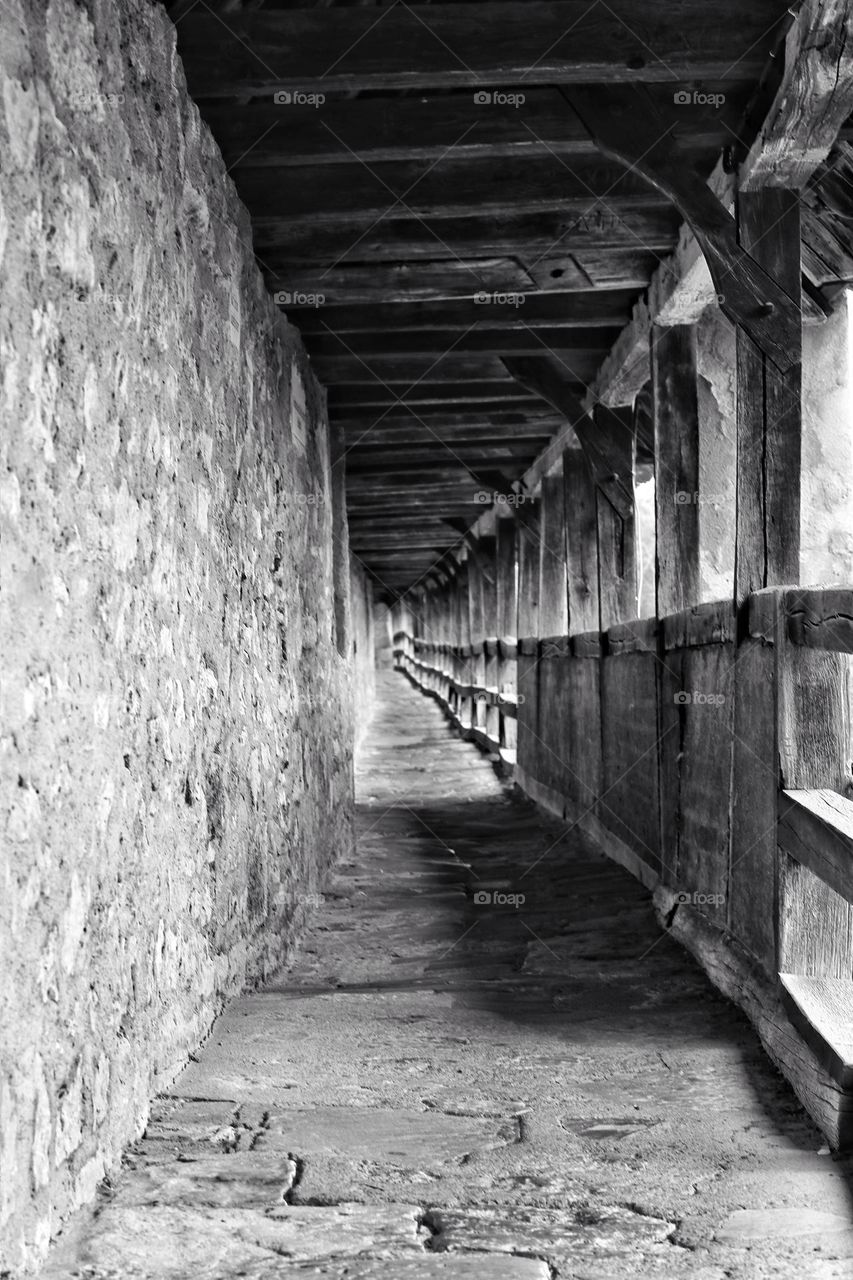 Black and white photo of an arcade on an old city wall