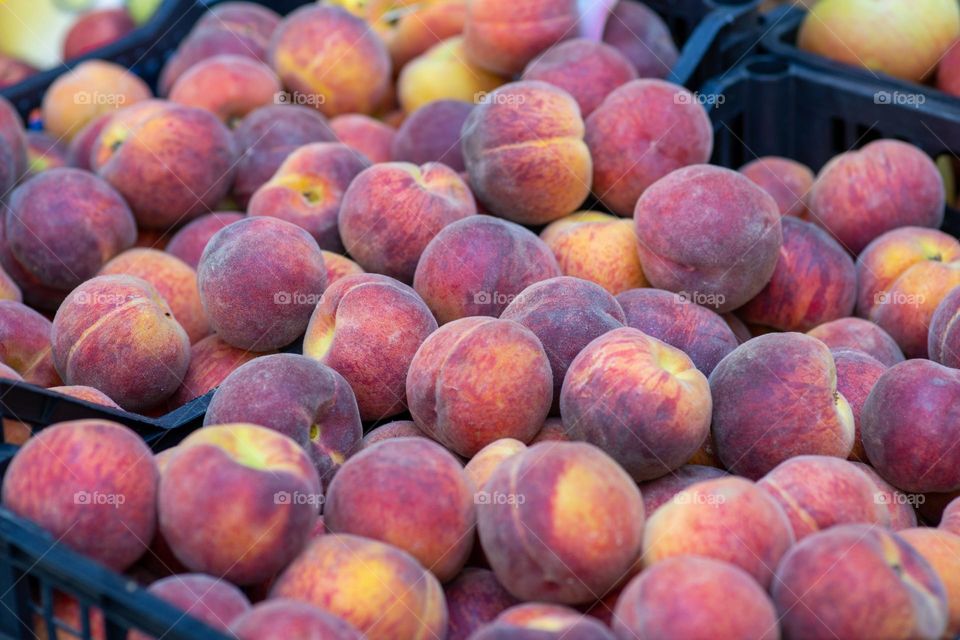 fresh peaches on a market stall