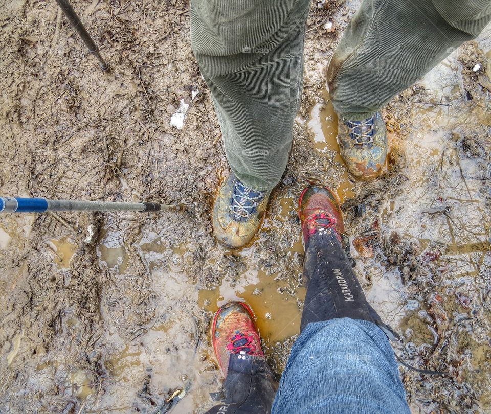 Hiking boots on a muddy trail.