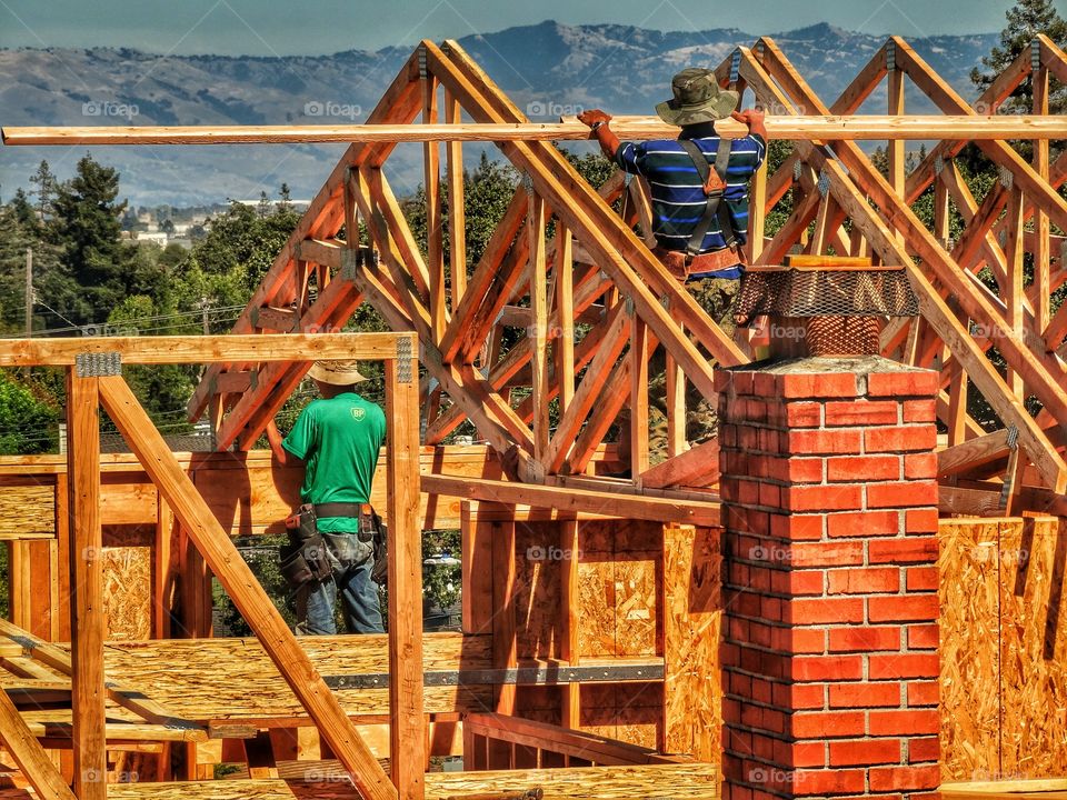 Construction Workers Building A House