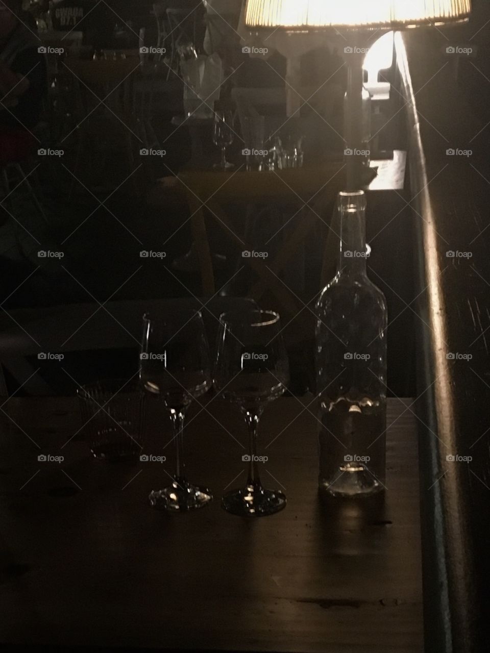Bottle and glasses at night