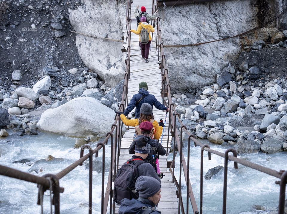 Georgia-October 18 2019:Traveller team are walking on Wooden suspension bridge to see beautiful Glacier in Georgia 