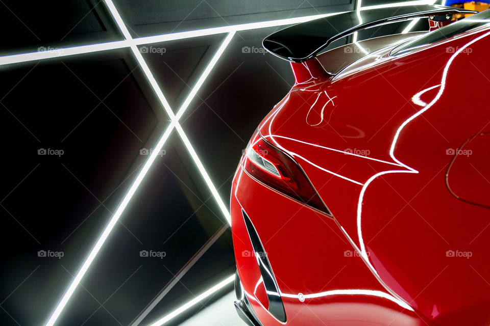 Red luxury car, closeup details with artificial lighting