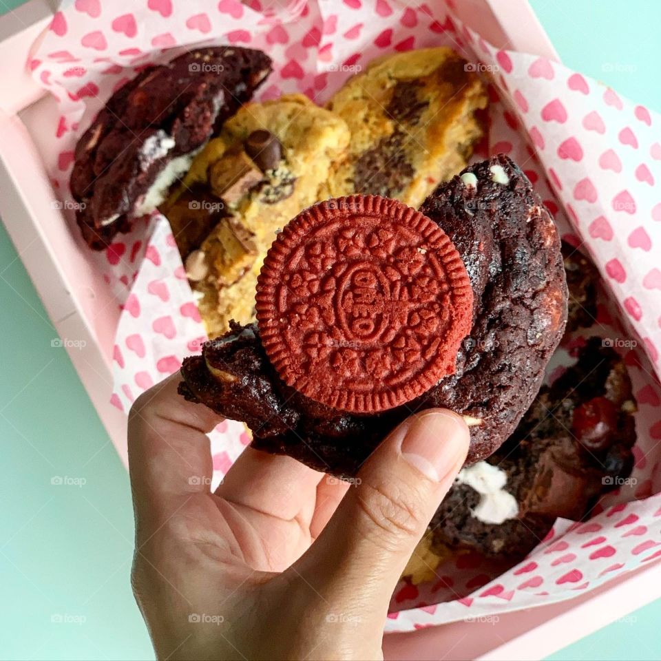Freshly baked Gooey Easter cookies in chocolate in big chunk with hot tea for afternoon snack 