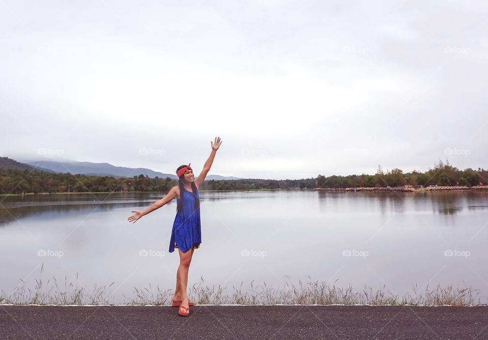 Female person enjoys at lakeside 