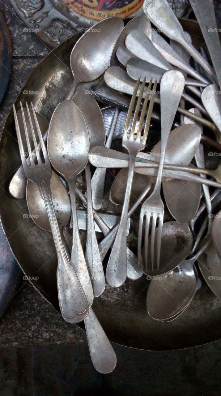 Old spoons sold in the market.