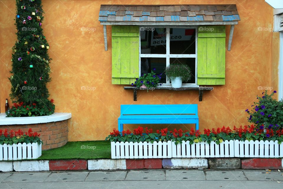 Window.. Beautiful wooden window on wall. Beauty decor with tree and bench. Thailand.