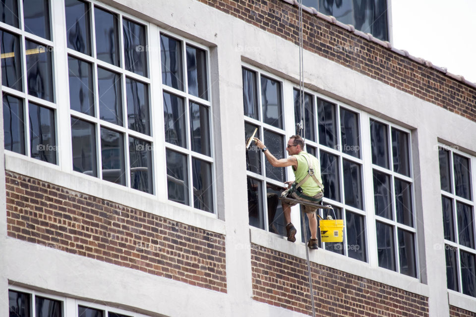 working in the city. cleaning high windows
