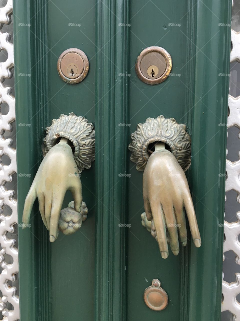 Two woman’s hands as door bells