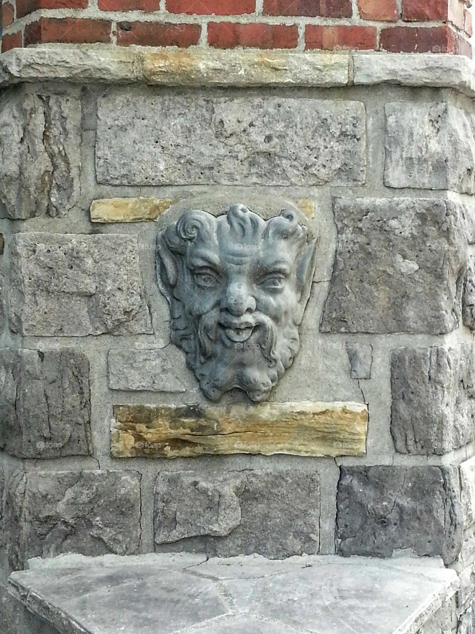 Gargoyle on a stone wall in Montreal