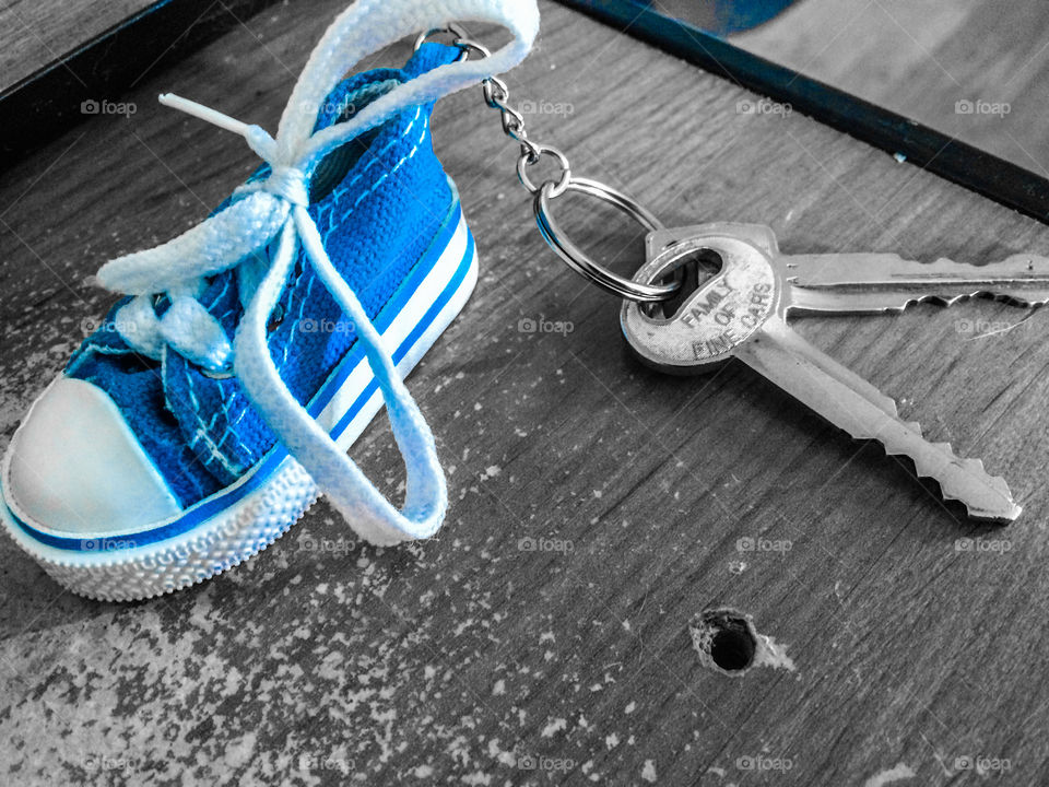 Blue pop color image of keychain with fake shoe 