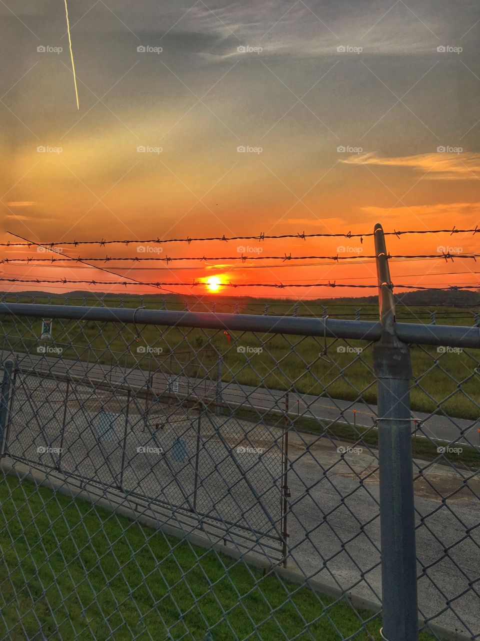 Sunset through barb wire 