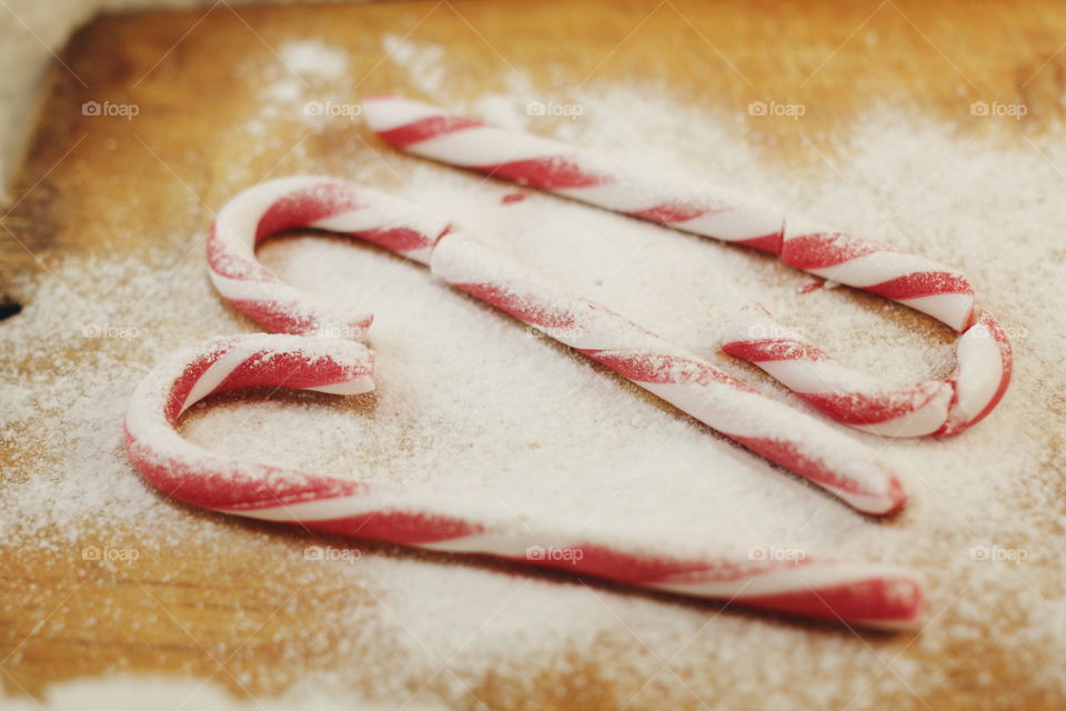 Candy canes on wooden floor