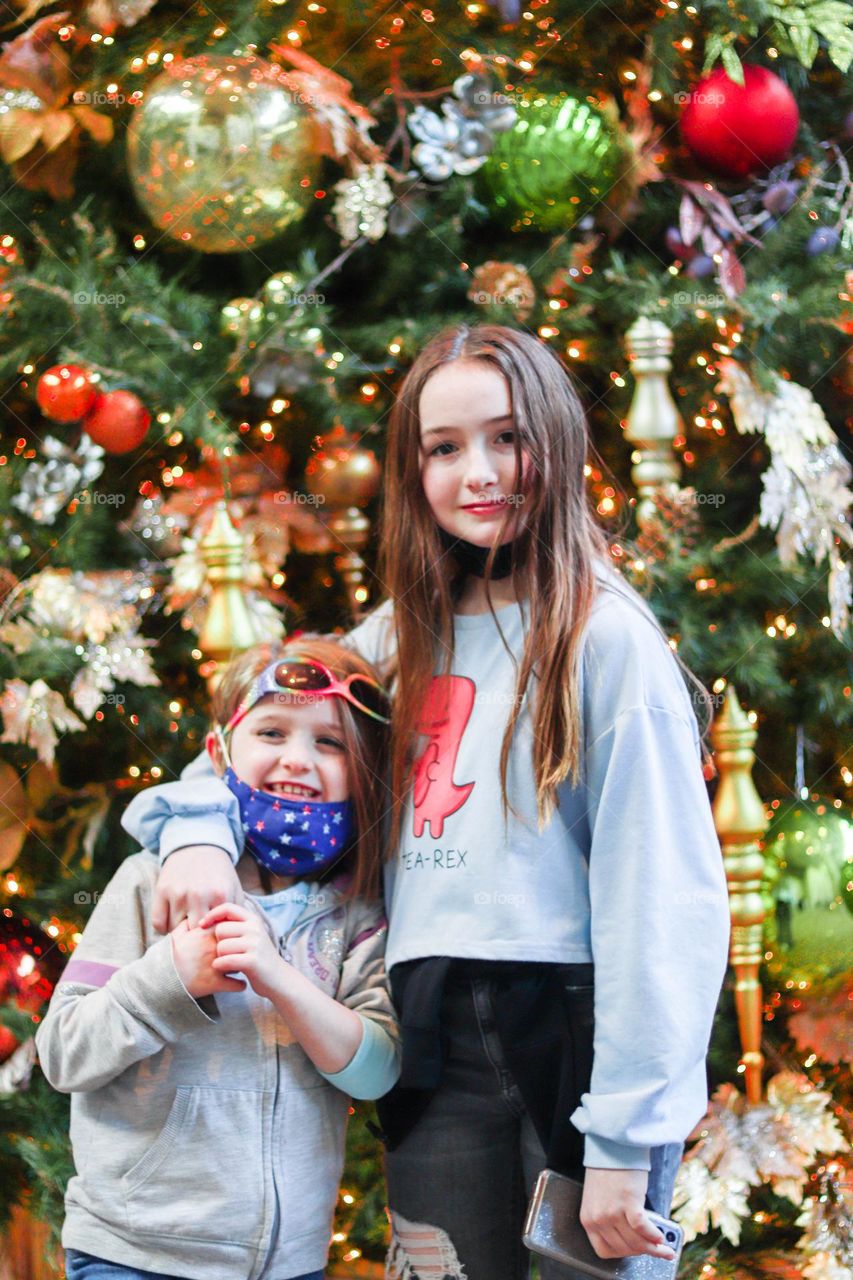 sisters by a Christmas tree