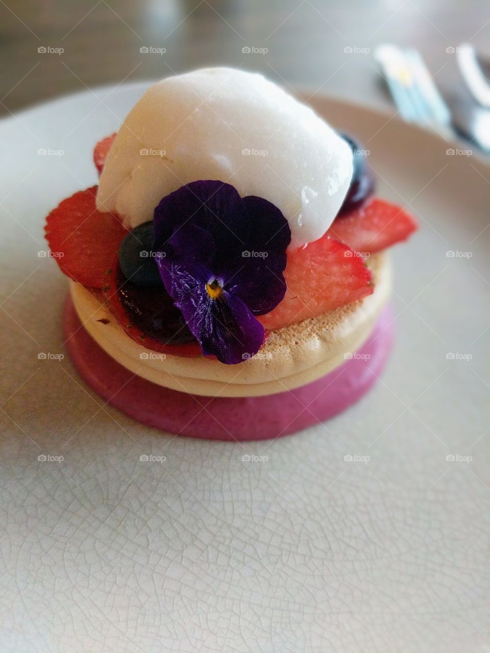 Fancy dessert with strawberries, ice cream and flower