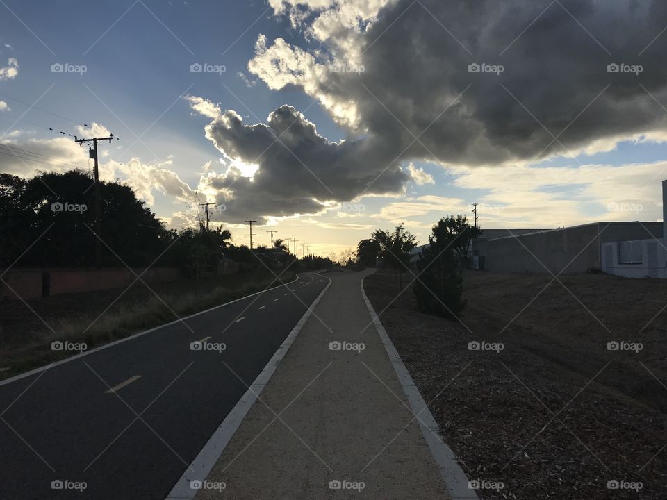 The sun setting on a clean bike and diet running path