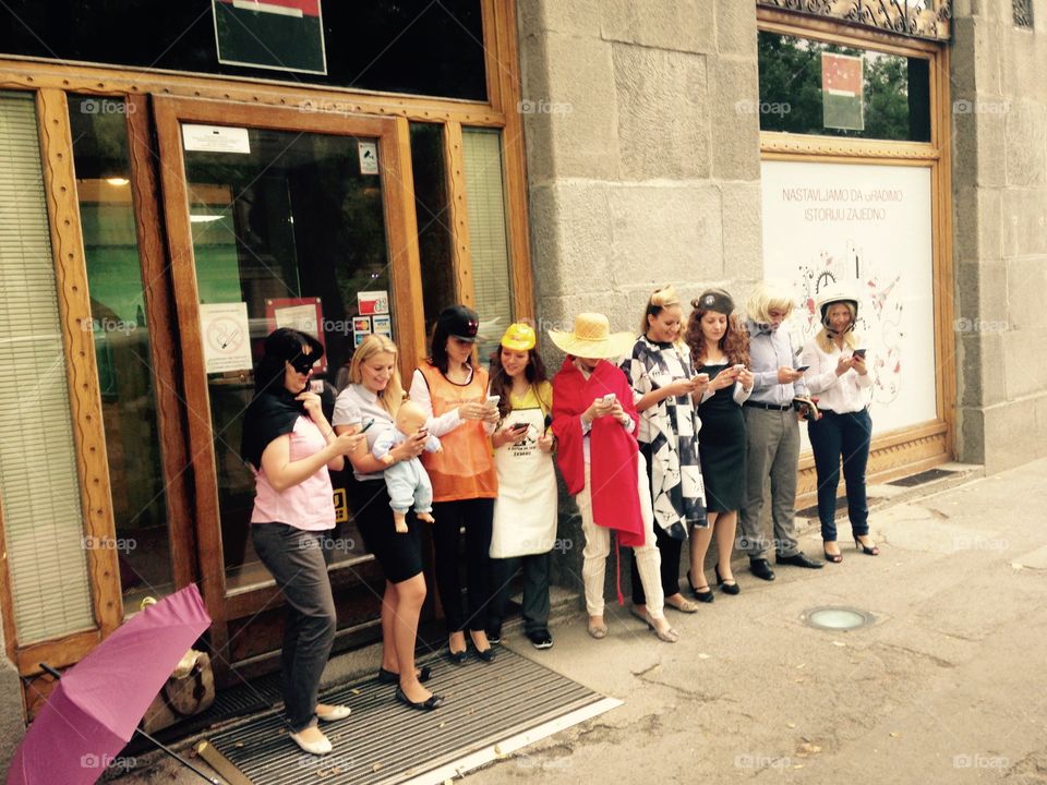 Masked people in front of bank