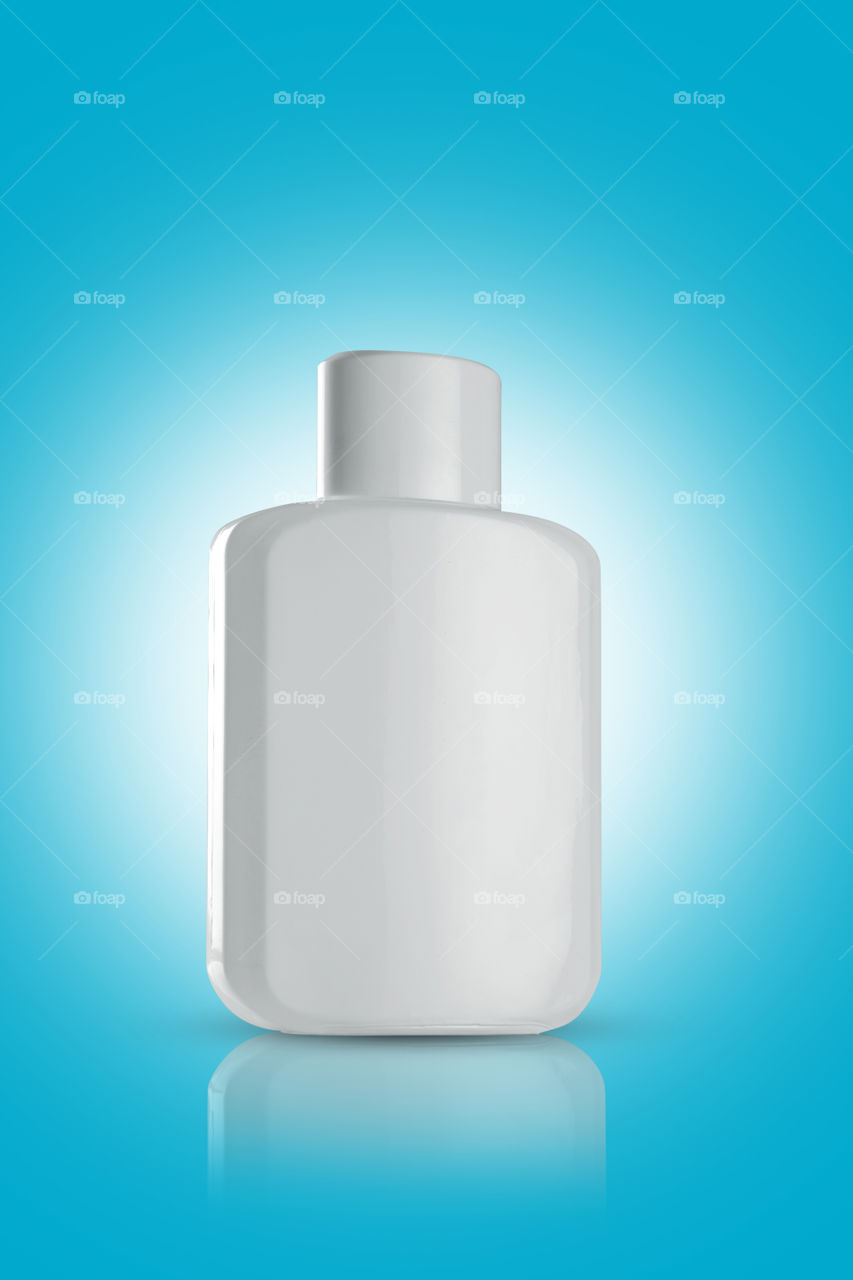 White perfume bottle on blue background