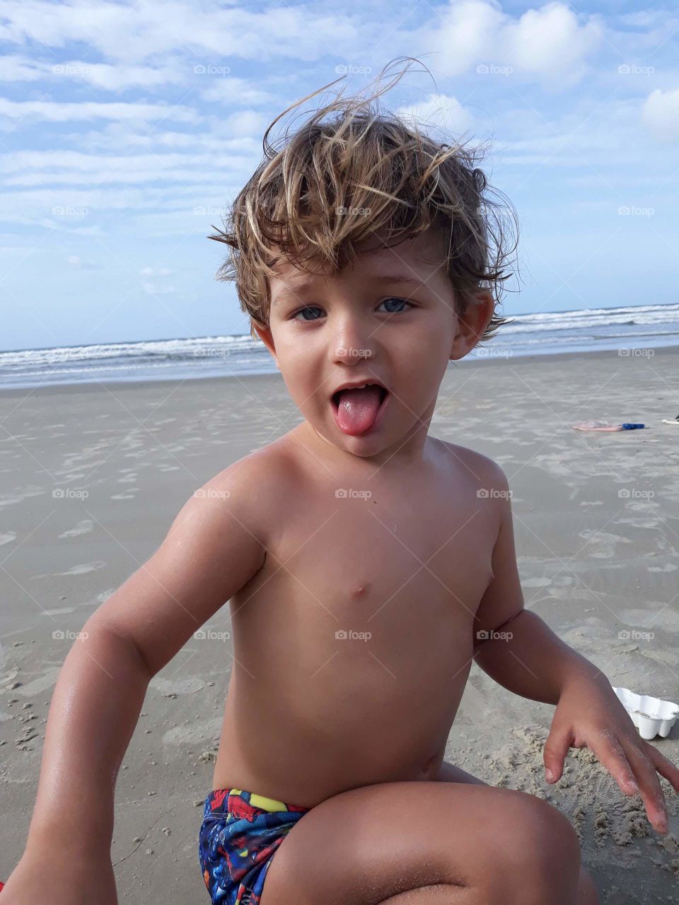 child putting tongue because he is hungry