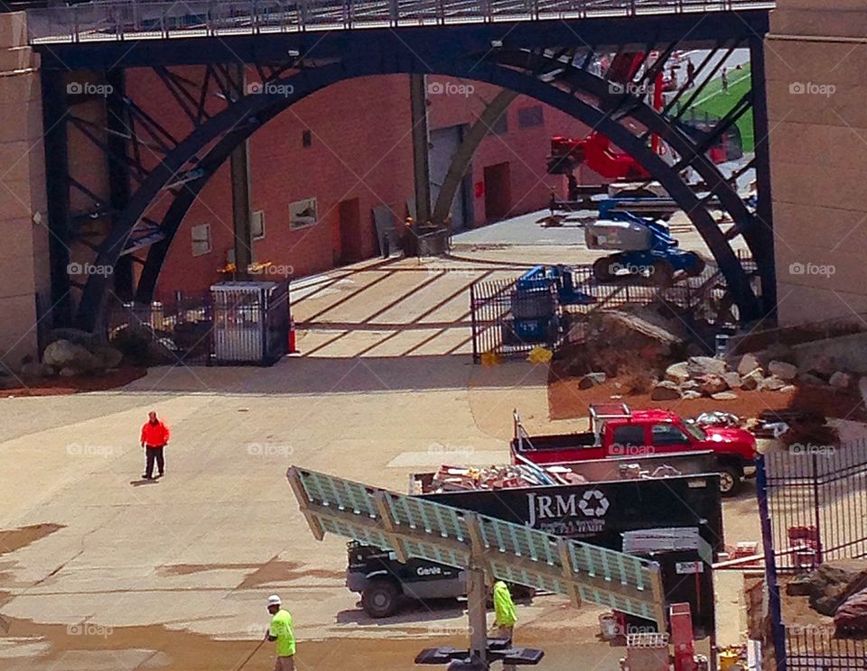 Under construction. Installing solar panels and adding on to the stadium - construction engineers mission