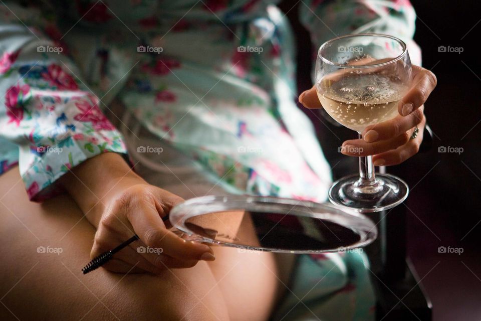 Reflection. Woman holding wine and mirror