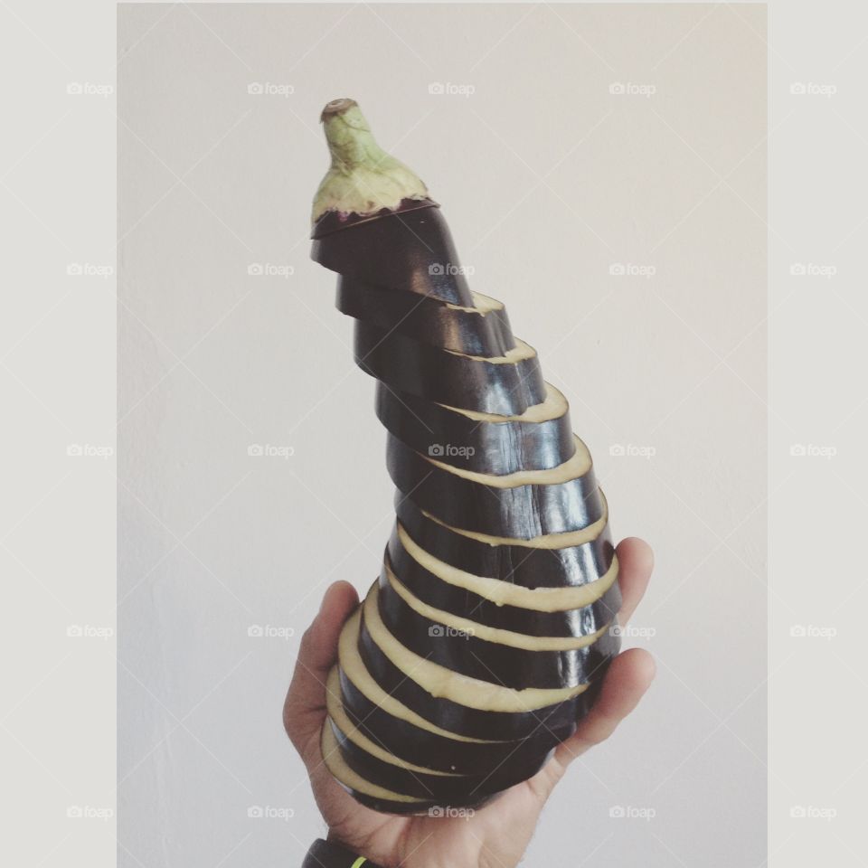 Sliced eggplant in hand