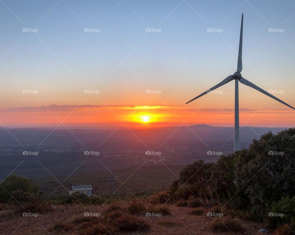 A wind turbine at sunset