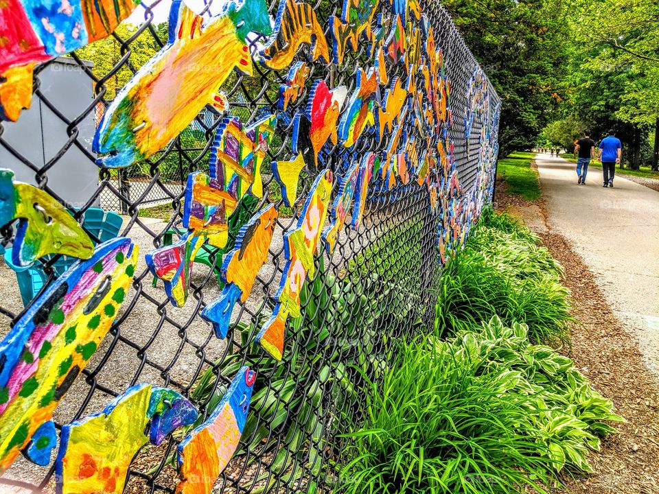 Walk in the park by a colorful wall of fish