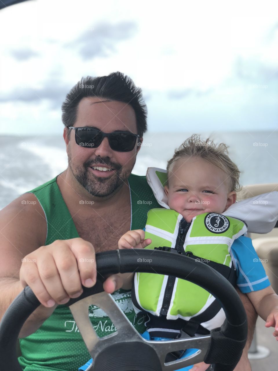 Father son driving boat 