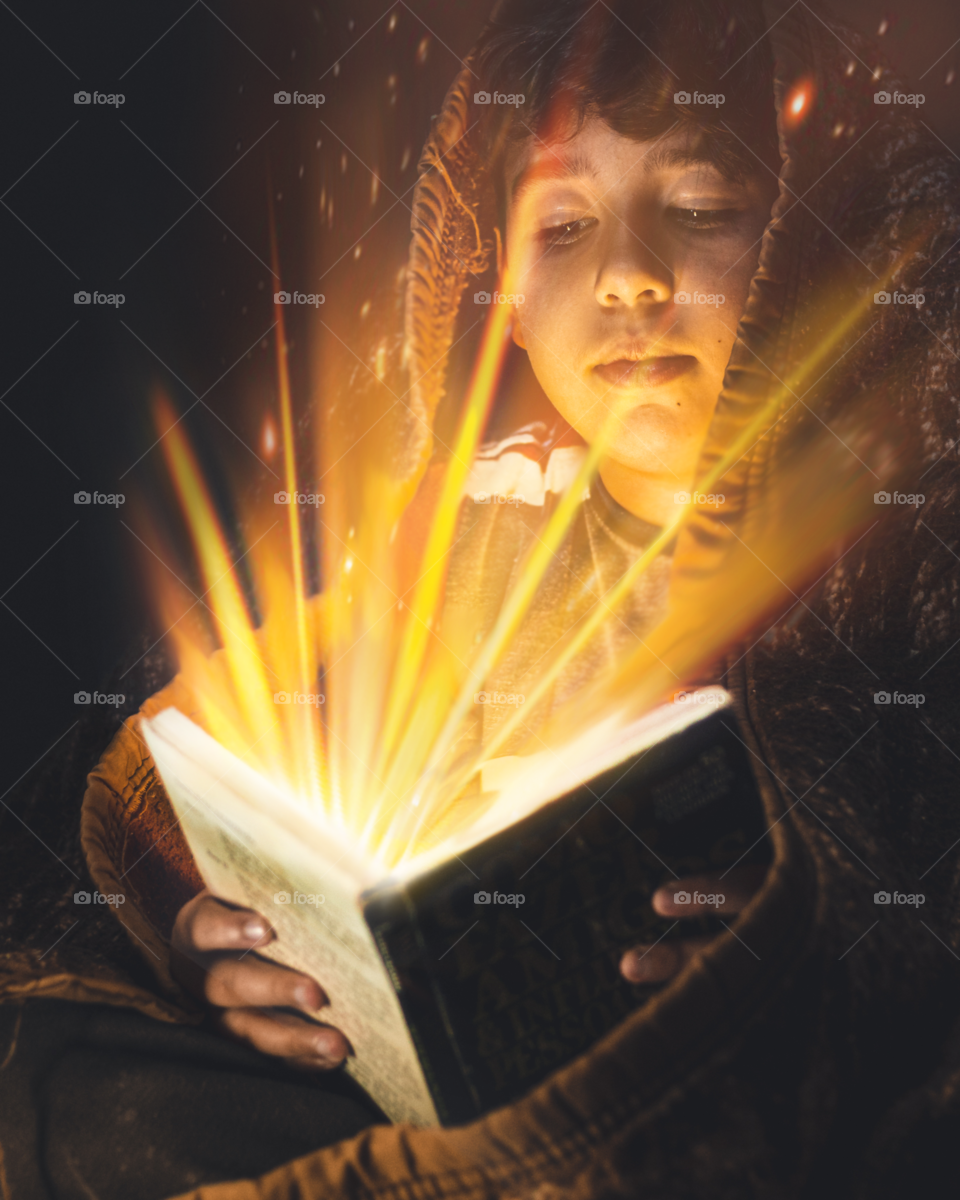 boy reading book with magic teachings