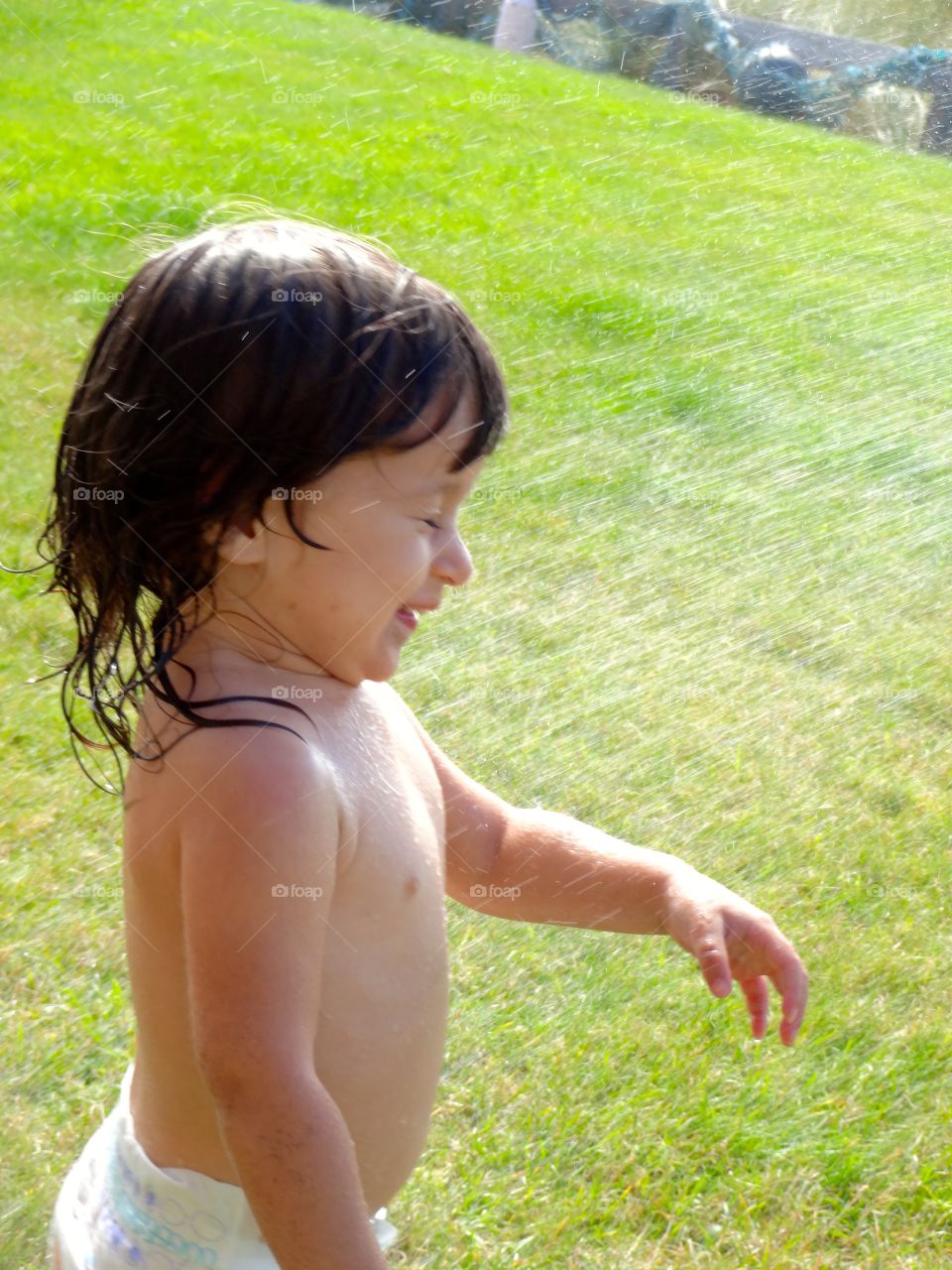 Water splashing on little girl