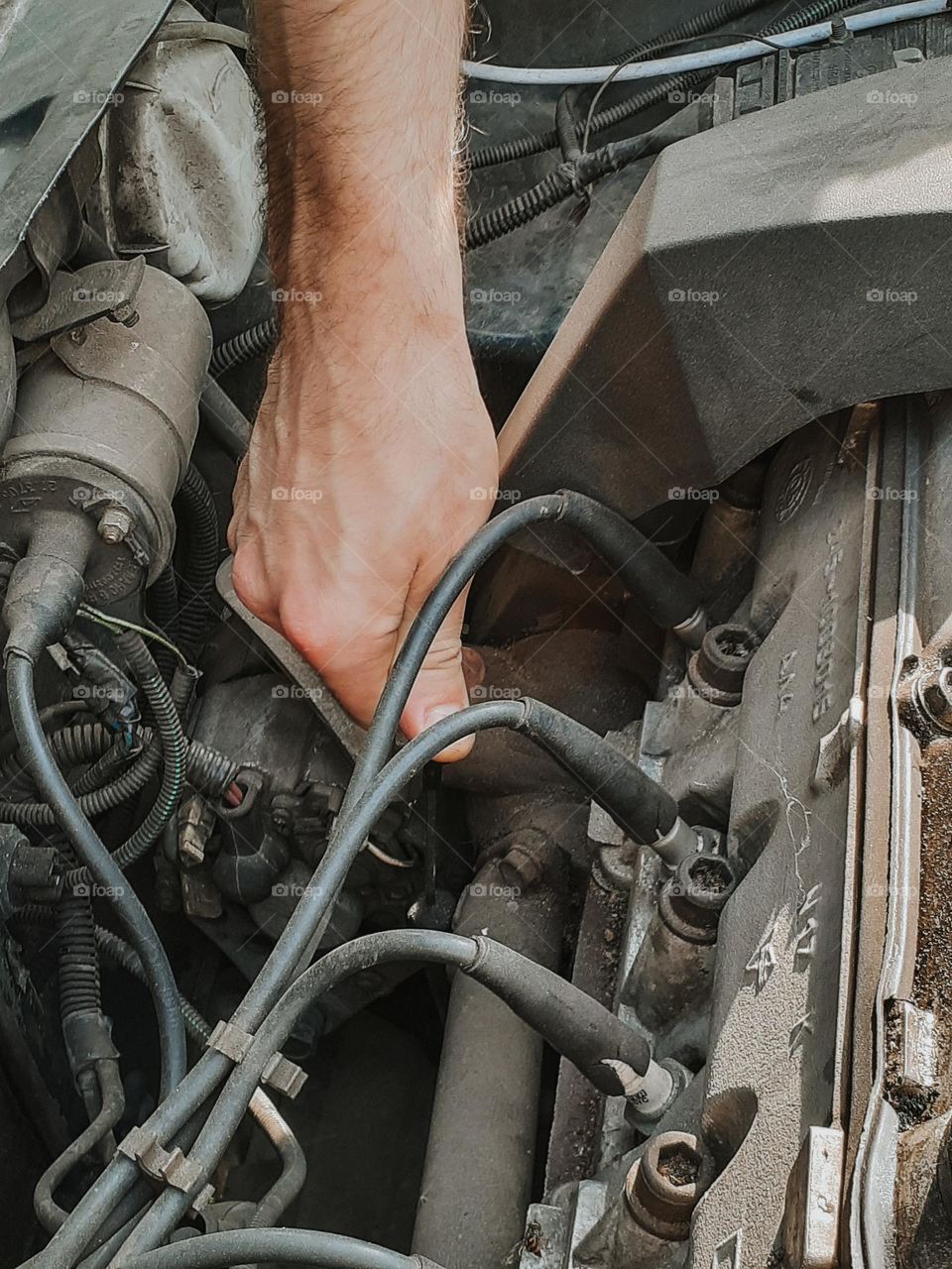 The mechanic checks the oil in the car under the hood, close-up photo