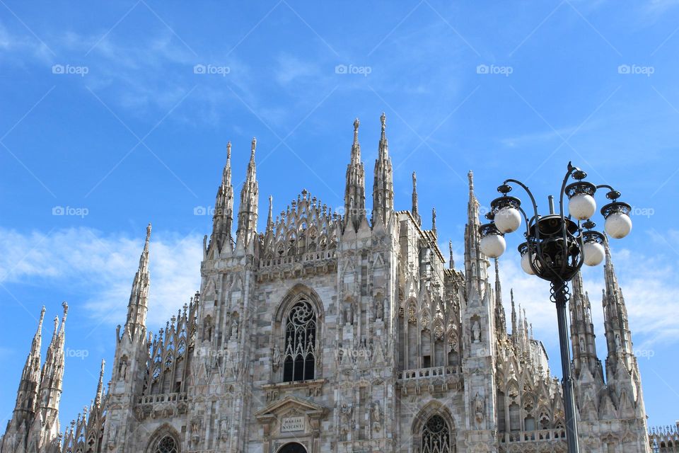 View of the Cathedral Duomo di Milano in the Central square of Milan.  Gothic architecture