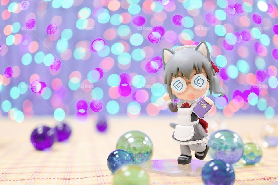 A Japanese maid model mini figure. A maid girl is wearing glasses and neko cat ears.