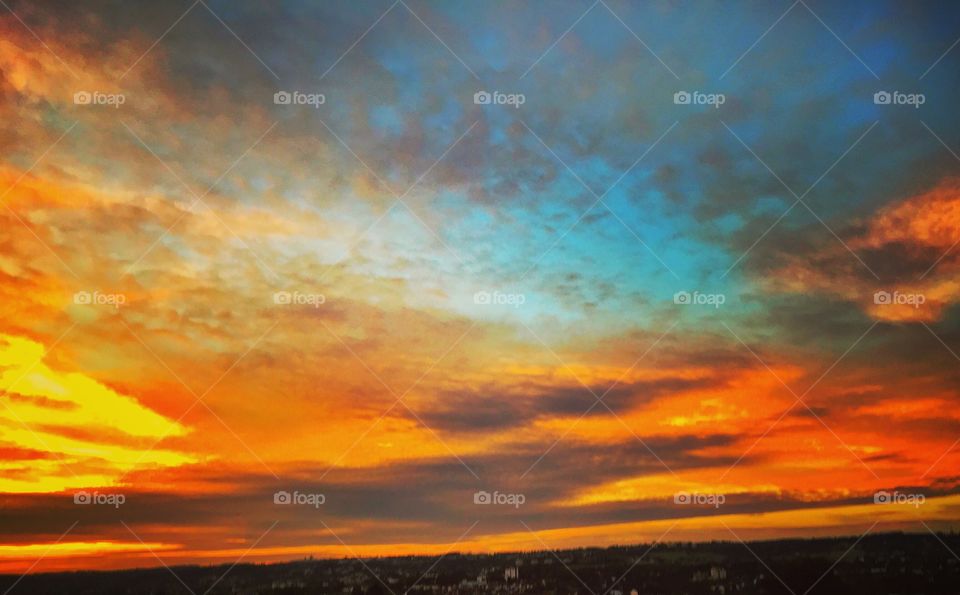 Sunset over town with dramatic sky