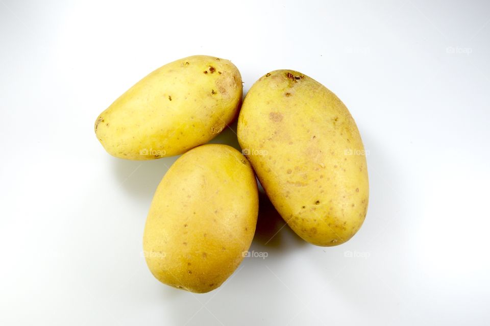 The potato over the white background 