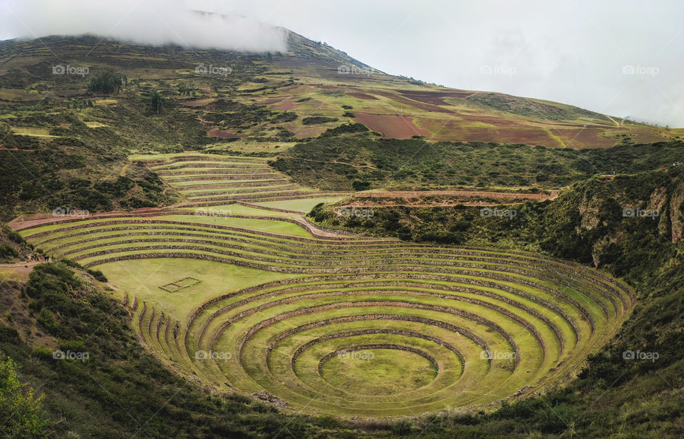 Inca archaeological site on a high plateau featuring a series of concentric terraces